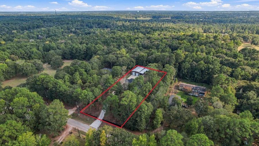 Aerial view of 19691 Village Forest Dr and the surrounding neighborhood